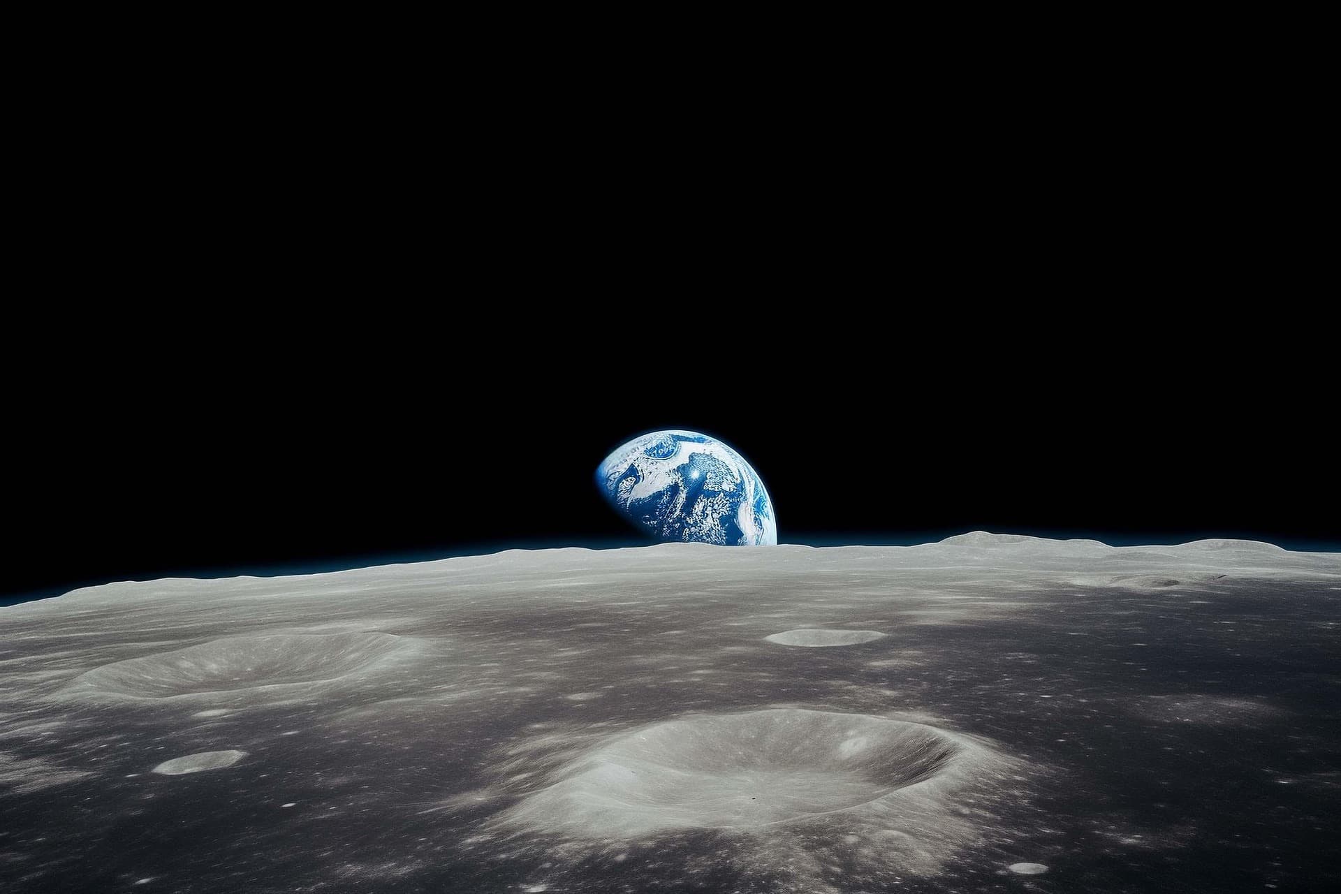 Earth rising over a cratered lunar horizon